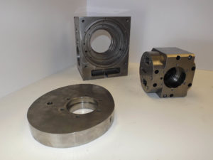 Cast Iron machined gear housings. Surface ground sides and cylindrical ground bores to .0002" tolerance. cam made from 4140 steel hardened and ground.