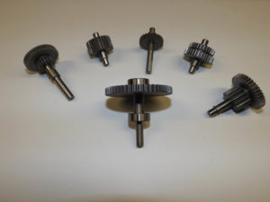 Gears made from 8620. Blanks cut, heat treated, hones and cylindrical ground. shafts made from 4140. Turned, heat treated, cylindrical and surface ground and sub-assembled.