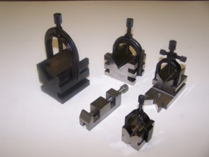 Precision ground V-blocks and clamps. Surface ground to .0003" perpendicularity, parallelism and "V" centrality. Assembled and packaged for dock to stock availability.